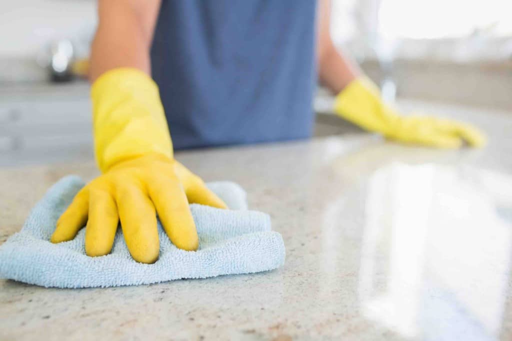 Woman cleaning the counter in the kitchen Woman cleaning the counter in the kitchen