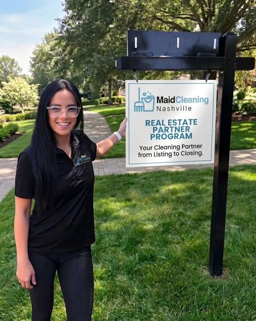 Woman beside a Maid Cleaning Nashville Real Estate Partner Program sign